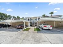 A lovely condo unit features assigned covered parking spots and mature landscaping at 414 Laurel Lake Dr # 203, Venice, FL 34292