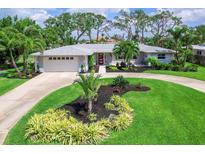Beautifully landscaped yard with circular driveway leading up to this immaculate home at 608 Apalachicola Rd, Venice, FL 34285