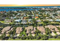 Waterfront homes with boat docks line a canal in this sunny aerial view of a coastal Florida community at 6724 Schooner Bay Cir # 6724, Sarasota, FL 34231