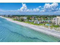Beautiful coastal condo community with white sand beach and turquoise water, perfect for relaxation at 700 Golden Beach Blvd # 115, Venice, FL 34285