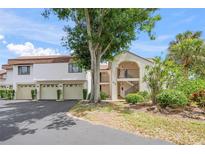 Inviting exterior featuring well-maintained landscaping and attached garages, creating curb appeal at 810 Capri Isles Blvd # 230, Venice, FL 34292