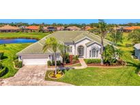 Inviting home with a well-manicured lawn, mature palm trees, and lush landscaping creates a picturesque curb appeal at 854 Blue Crane Dr, Venice, FL 34285