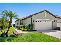 Charming single-story home with a lush lawn, mature landscaping, and a convenient two-car garage at 11343 Bertolini Dr, Venice, FL 34292