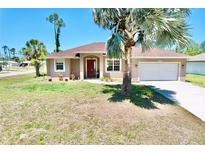 Charming single-story home with a well-manicured lawn and attached two-car garage at 1510 Haffenberg Ave, North Port, FL 34288
