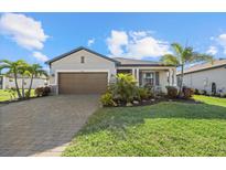 Charming single-story home features a well-manicured lawn and lovely landscaping at 2000 Gardenia Ave, Port Charlotte, FL 33953