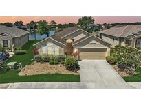 Charming home boasts a well-manicured lawn, mature landscaping, and a serene waterfront view at 24477 Lakeside Mnr, Punta Gorda, FL 33980