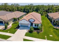 Beautiful aerial view of the charming single-Gathering home with a well-manicured lawn and a tile roof at 264 Caserta Ct, Nokomis, FL 34275