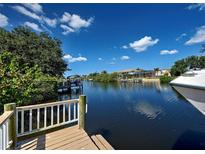Scenic waterfront view featuring a private dock and canal access on a clear, sunny day at 617 Bonito Ave, Nokomis, FL 34275