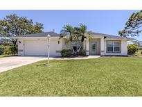 Inviting one story home featuring mature landscaping, an attached two car garage and a manicured lawn at 791 Cumberland Rd, Venice, FL 34293