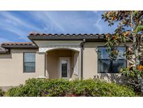 Charming home featuring an inviting front door and decorative accents with well manicured landscaping at 12515 Felice Dr, Venice, FL 34293