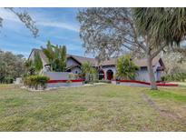 A charming residence featuring a well-manicured lawn and vibrant tropical landscaping at 181 S Auburn Rd, Venice, FL 34292