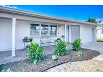 Inviting front porch with tile flooring, charming bench, and freshly landscaped garden at 2108 Lee Ln, Sarasota, FL 34231