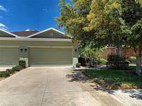 Charming home featuring an attached two-car garage, lovely landscaping, and a well-manicured lawn at 275 Capulet Dr, Venice, FL 34292