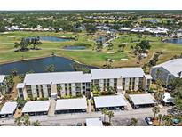 Stunning aerial view of condo community overlooking lush golf course with serene lakes and verdant landscaping at 406 Cerromar N Cir # 128, Venice, FL 34293