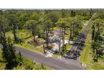 A bird's eye view of the cozy home surrounded by verdant trees at 5992 Osprey Rd, Venice, FL 34293