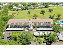 Beautiful condo complex with golf course views, lush landscaping, and convenient covered parking at 1018 Wexford Blvd # 1018, Venice, FL 34293