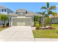 Charming single-story home featuring a tile roof, two-car garage, and beautifully landscaped front yard at 12478 Sagewood Dr, Venice, FL 34293