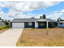 Charming single-story home with a well-maintained lawn and a spacious two-car garage at 144 Rotonda Cir, Rotonda West, FL 33947