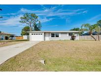 Charming single-story home with a well-manicured lawn and attached garage in a quiet neighborhood at 2980 Siesta Dr, Venice, FL 34293