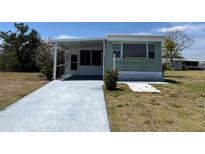 Charming single-story home with a covered patio and a well-maintained lawn at 6741 Laurel Ct, North Port, FL 34287
