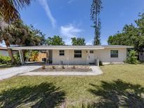 Charming single-story home with a covered carport and a well-manicured front lawn at 929 Cypress Ave, Venice, FL 34285