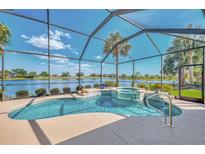 Gorgeous screened-in pool and jacuzzi with a lovely view of the serene lake, perfect for relaxation at 138 Rimini Way, North Venice, FL 34275
