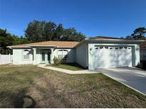 Charming single-story home featuring a two-car garage, manicured lawn, and beautiful curb appeal at 1483 Prairie Ter, North Port, FL 34286