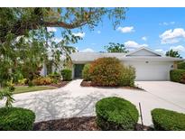 Well maintained single story home with mature landscaping, and a large driveway to the attached two car garage at 1833 Raintree Ln, Venice, FL 34293