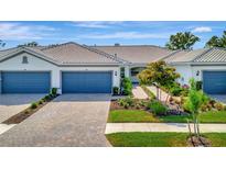 Charming single-story home with well-maintained landscaping and a brick driveway, perfect for easy living at 25069 Pearl Lake Cir, Englewood, FL 34223
