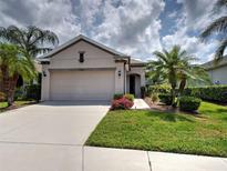 Charming single-story home with well-manicured lawn and mature palm trees at 25784 Grayton Ave, Englewood, FL 34223