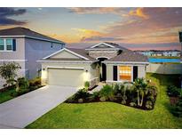 Charming single-Gathering home with lush landscaping, neutral tones, and a two-car garage at 5222 Granite Dust Pl, Palmetto, FL 34221