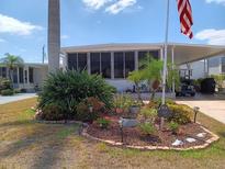Charming home with lush landscaping and an American flag proudly displayed at 603 Leisure, Venice, FL 34285