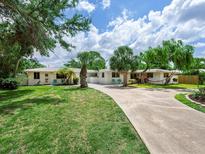 Charming home with a well-maintained lawn and long driveway leading to the beautiful property at 607 Bay Point Ave, Nokomis, FL 34275