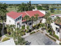 Beautiful condo with a red roof and palm trees at 758 Village Cir # 106, Venice, FL 34292