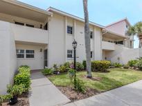 Inviting condo exterior featuring well-manicured landscaping and a welcoming entrance at 758 Village Cir # 106, Venice, FL 34292