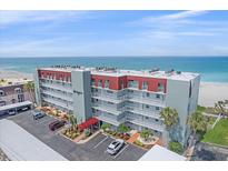 A beautiful high rise condo building with beach front views and a parking area at 950 Tarpon Center Dr # 504, Venice, FL 34285