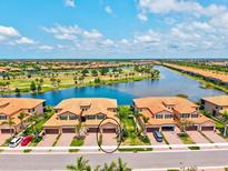 Beautiful aerial view of a townhome community with lake and golf course views at 10808 Tarflower Dr # 102, Venice, FL 34293