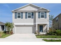 Charming two-story home featuring blue shutters, manicured lawn, and an attached two car garage at 11228 Fieldstone Dr, Palmetto, FL 34221