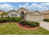 Charming single-story home with manicured landscaping and a two-car garage at 143 Braemar Ave, Venice, FL 34293