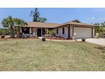 Charming single-story home featuring a 2-car garage, manicured lawn, and inviting front entrance at 2331 Mission Valley Blvd, Nokomis, FL 34275