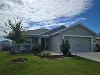 Charming single-story home featuring a well-manicured lawn and attached two-car garage at 3003 58Th E Way, Palmetto, FL 34221