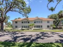 Multi-Gathering home with a red tile roof and neatly maintained landscaping at 528 W Venice Ave # 1, Venice, FL 34285