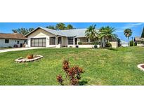 Charming single-story home featuring a well-maintained lawn and mature landscaping in a desirable neighborhood at 5832 Monroe Rd, Venice, FL 34293