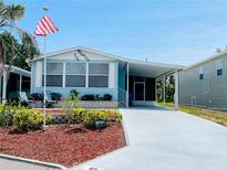 Charming single-story home with well-manicured lawn, covered parking, and cozy patio at 615 S Green Cir, Venice, FL 34285