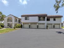 Well-maintained condo building with private garages and lush landscaping at 800 Capri Isles Blvd # 124, Venice, FL 34292