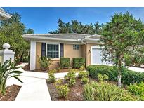 Charming home with a landscaped front yard, walkway and tiled roof at 912 Barclay Ct, Venice, FL 34293