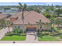 Elegant home showcasing a terracotta roof, well manicured landscaping, and a paver driveway at 9220 43Rd W Ter, Bradenton, FL 34209