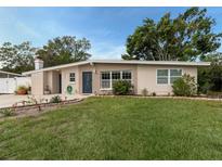 Charming single-story home with a well-maintained lawn and inviting blue front door at 161 Suntan Ave, Sarasota, FL 34237