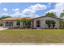 Charming single-story home featuring a well-manicured lawn and a welcoming front entrance at 318 Venice East Blvd, Venice, FL 34293