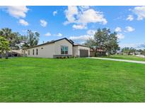 Well-maintained home with a lush green lawn and a view of the neighborhood at 4390 Asteria Ter, North Port, FL 34287